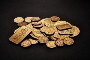 assorted gold bars and coins on a table