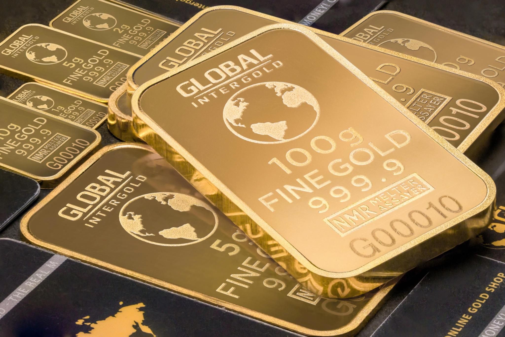 999.9 purity gold bars stacked on each other 999.9 purity gold bars stacked on each other